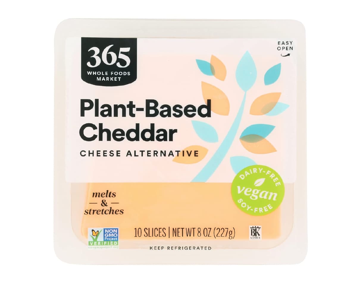 A clear package of Whole Foods 365 Plant-Based Cheddar against a white background. 