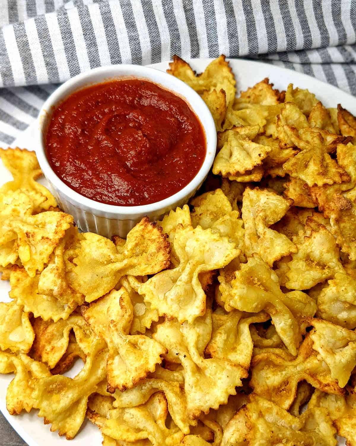 plate of air fried farfalle chips with marinara