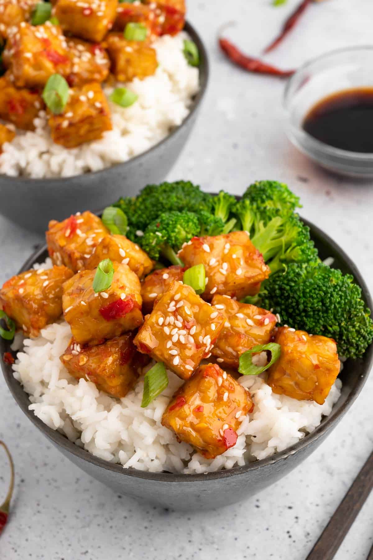 Air-fryer tempeh in a bowl with broccoli and rice.