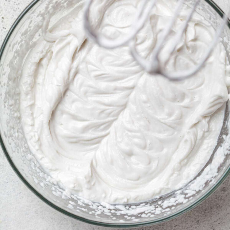Aquafaba whipped cream in a mixing bowl.