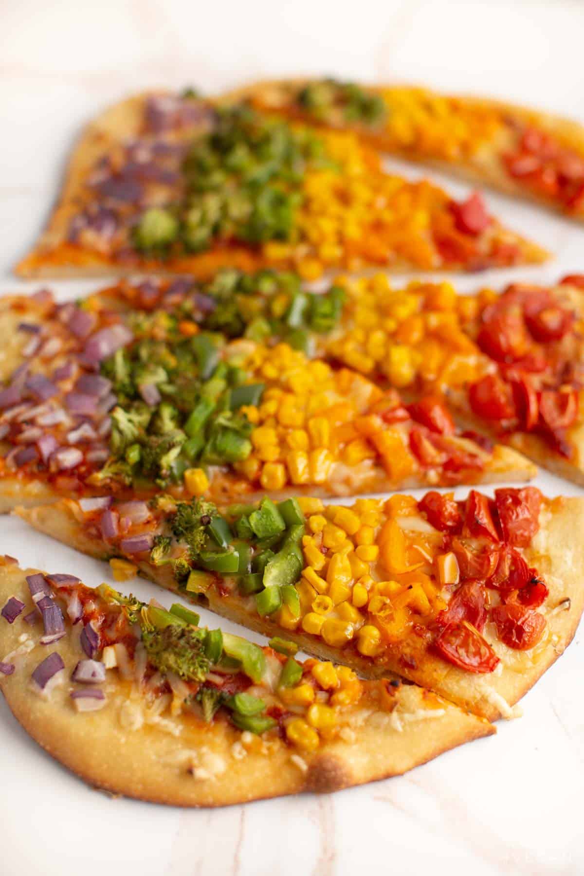 Baked rainbow pizza loaded with veggies. 