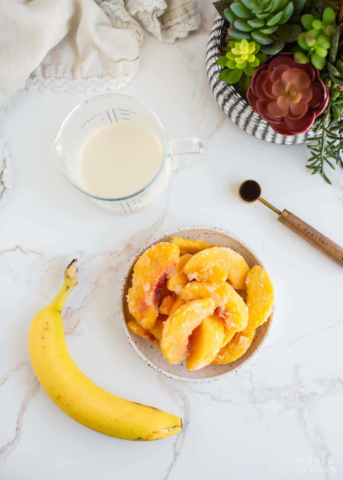 Ingredients for a banana peach smoothie laid out.