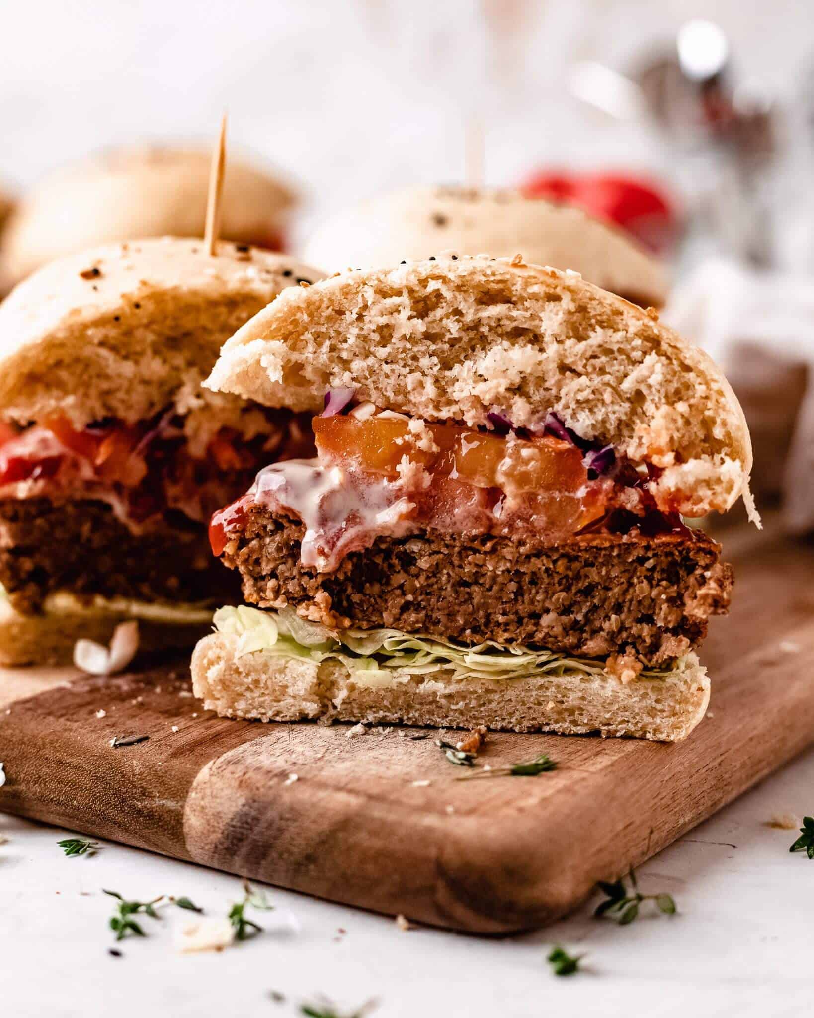 vegan lentil burger on a bun with lettuce and tomato