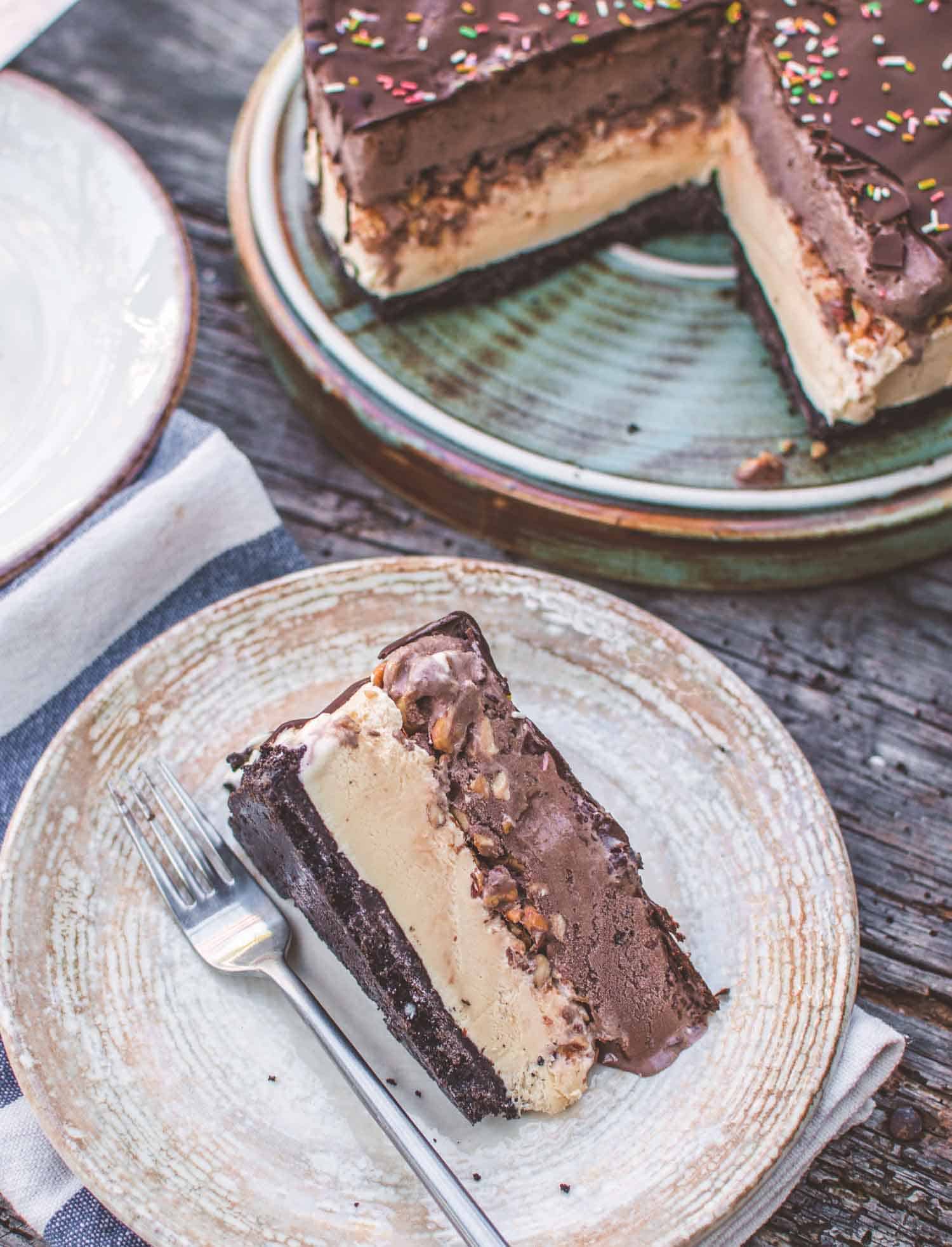 slice of vanilla and chocolate vegan ice cream cake served on a rustic plate