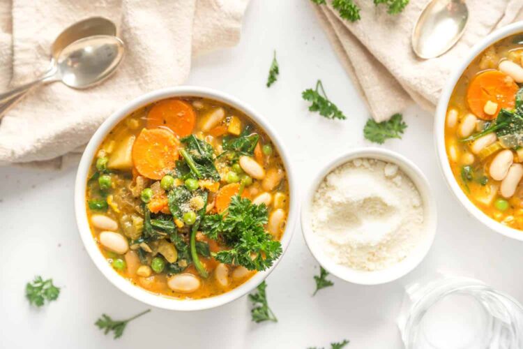 best vegan stew recipe served in white bowls with plant based parm