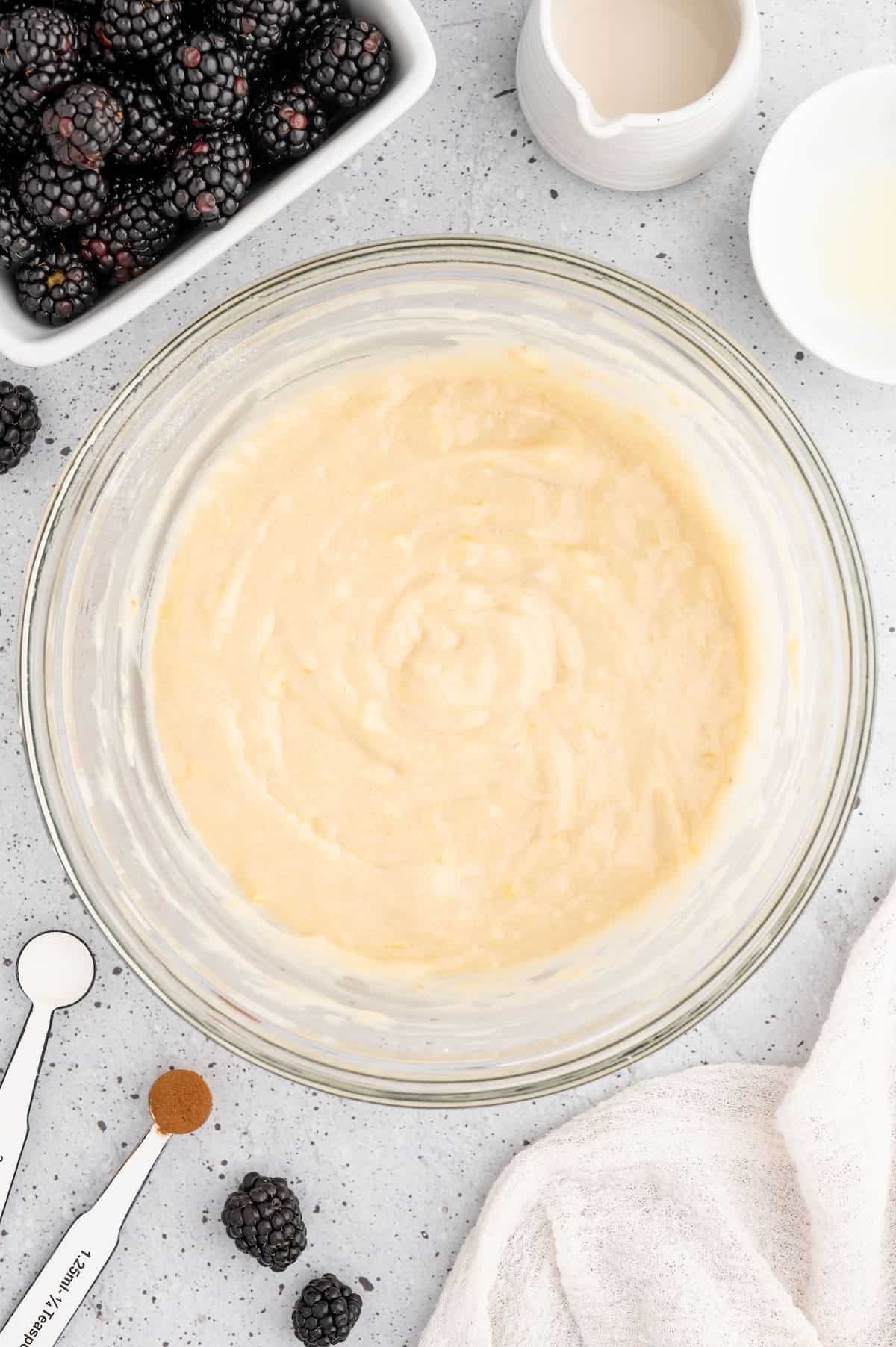 Mixed batter for vegan blackberry muffins in a bowl.