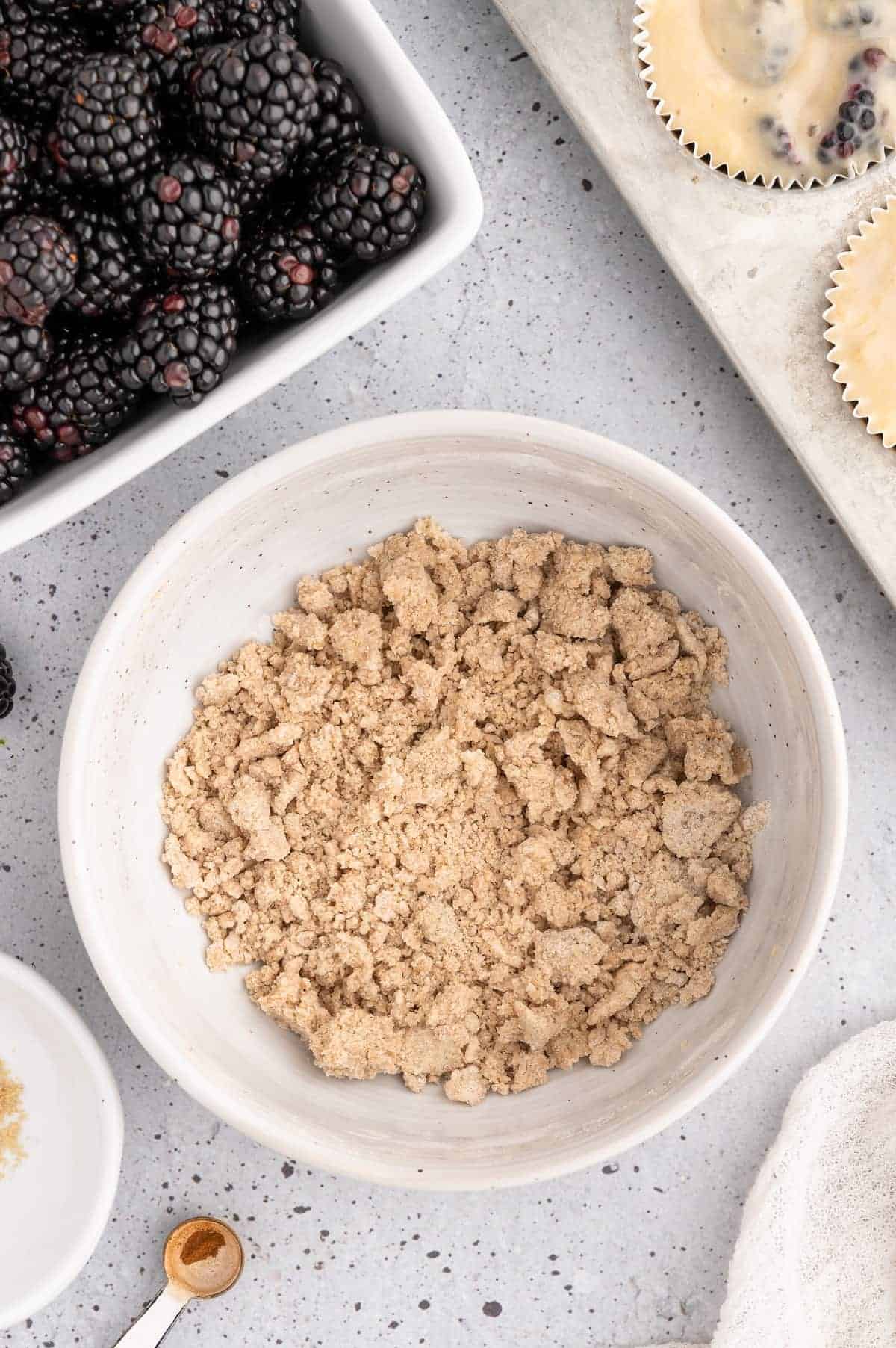 Crumb topping ingredients for blackberry muffins mixed together in a bowl.