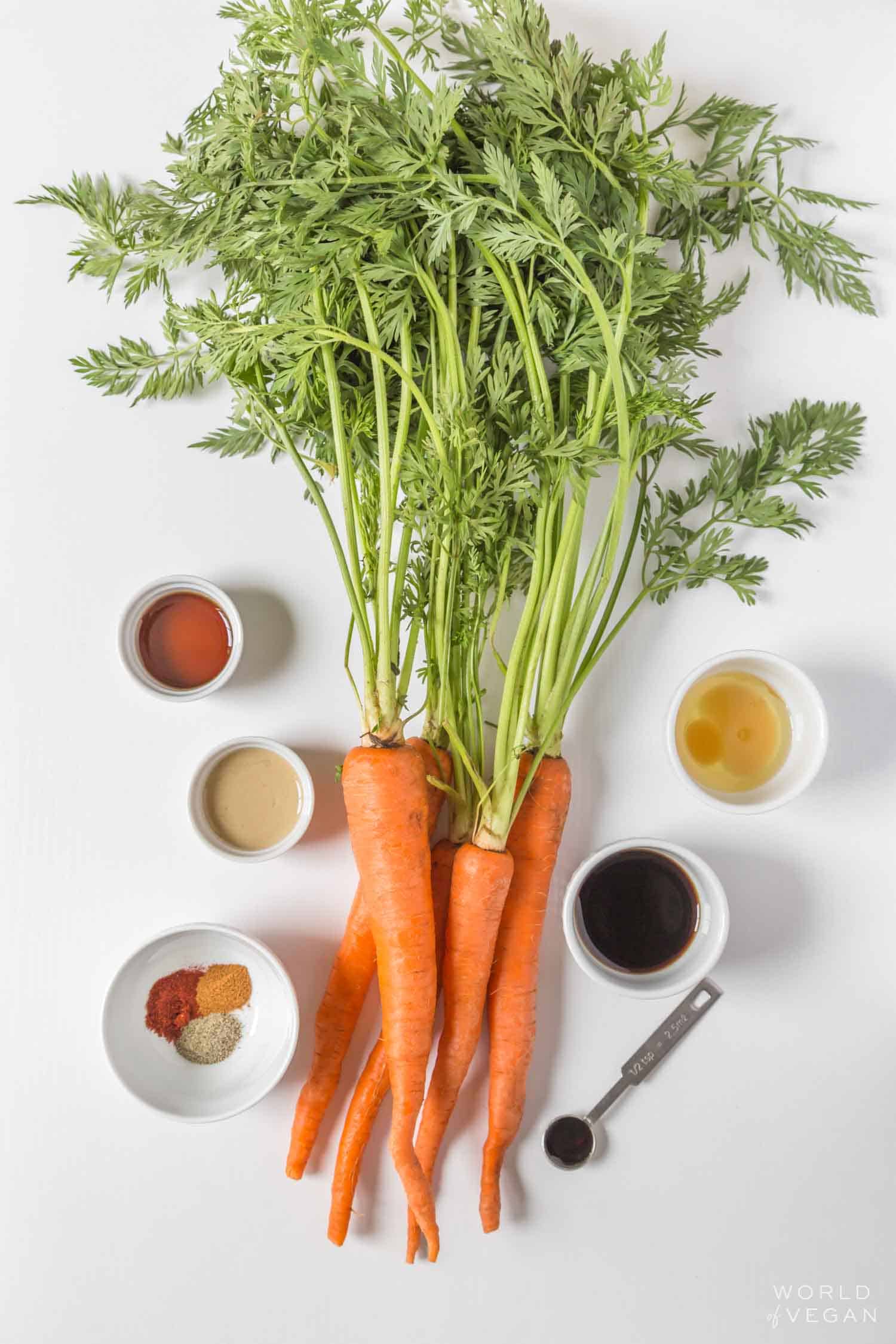 carrot bacon ingredients flatlay with a big bunch of carrots with the green carrot tops