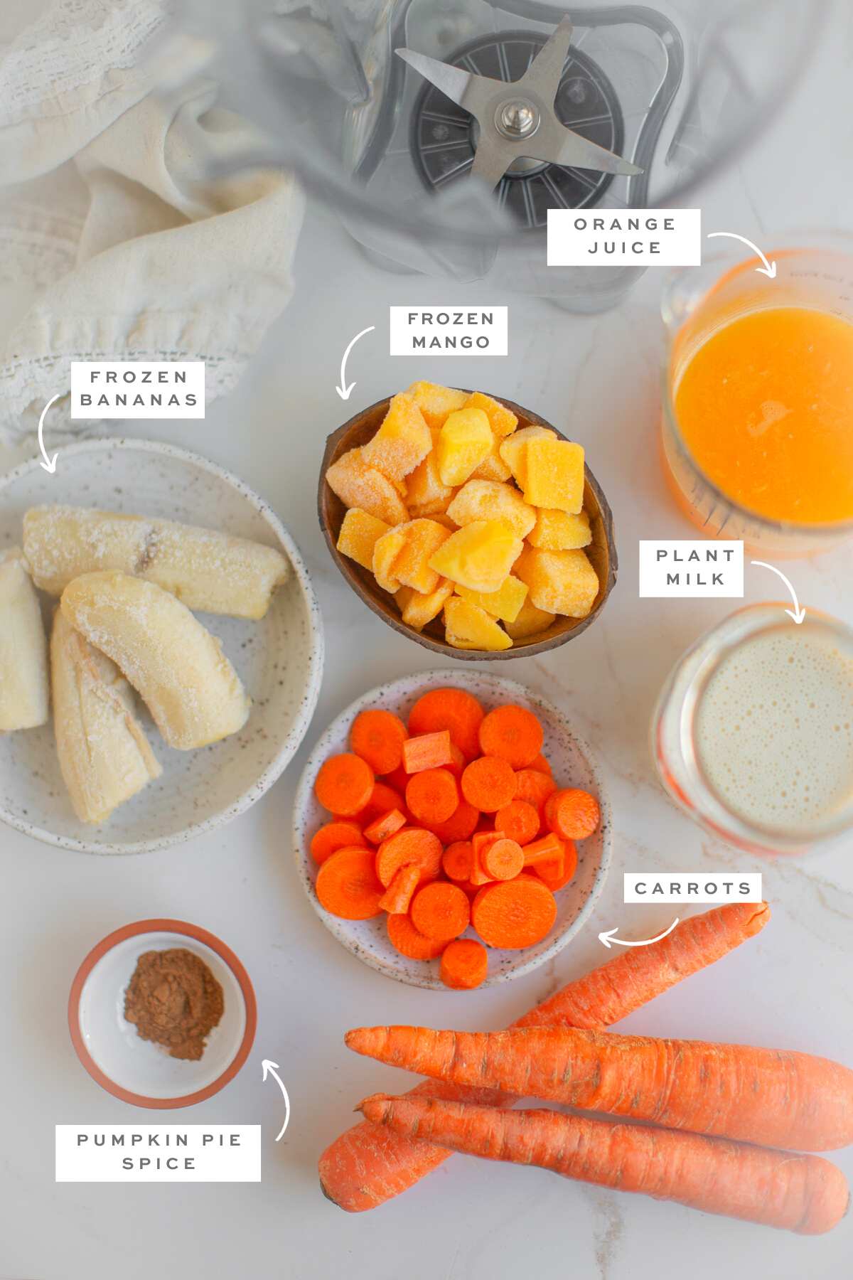 Gathered ingredients for this carrot smoothie recipe with labels.