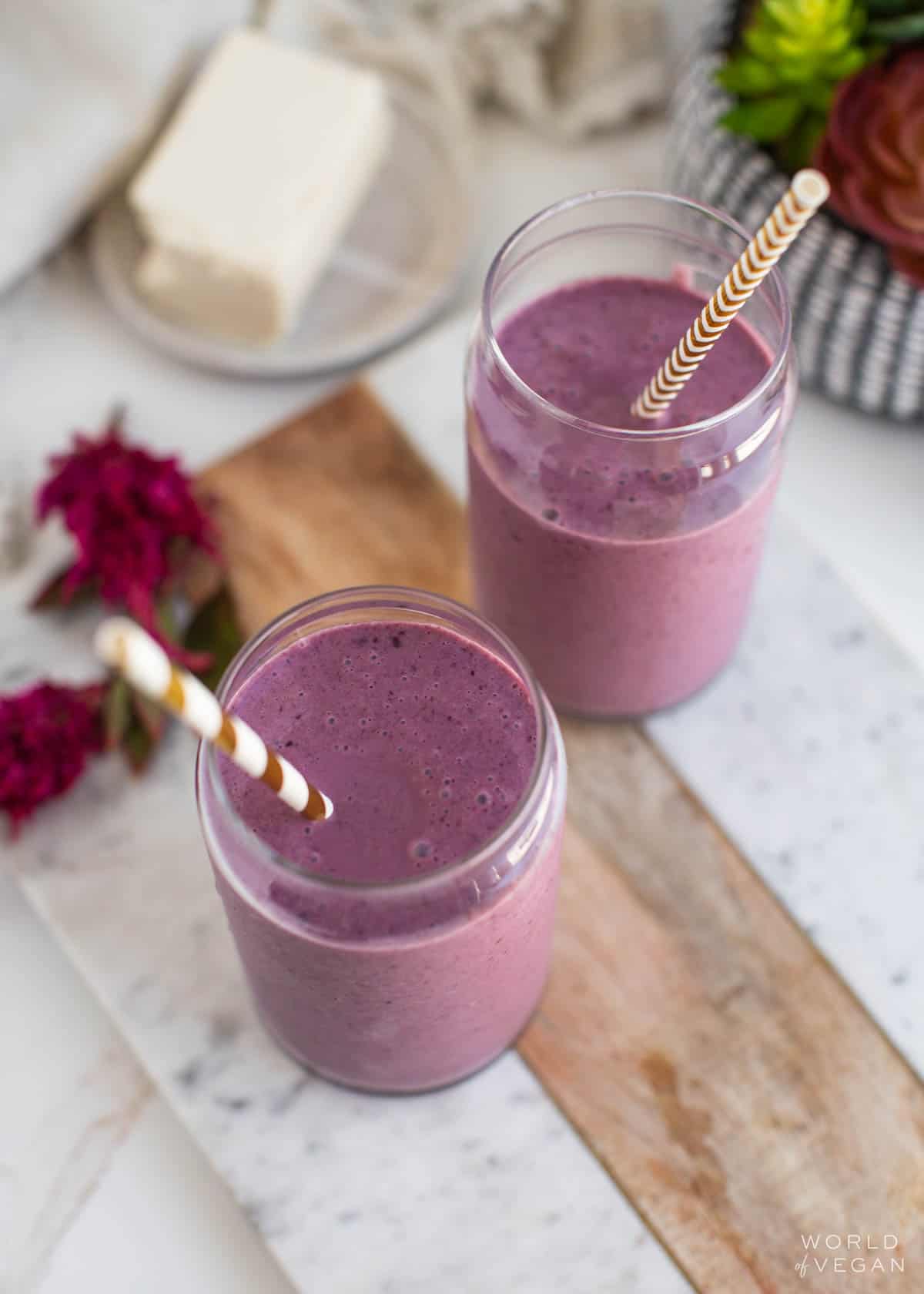 Two tofu smoothie glasses with straws.