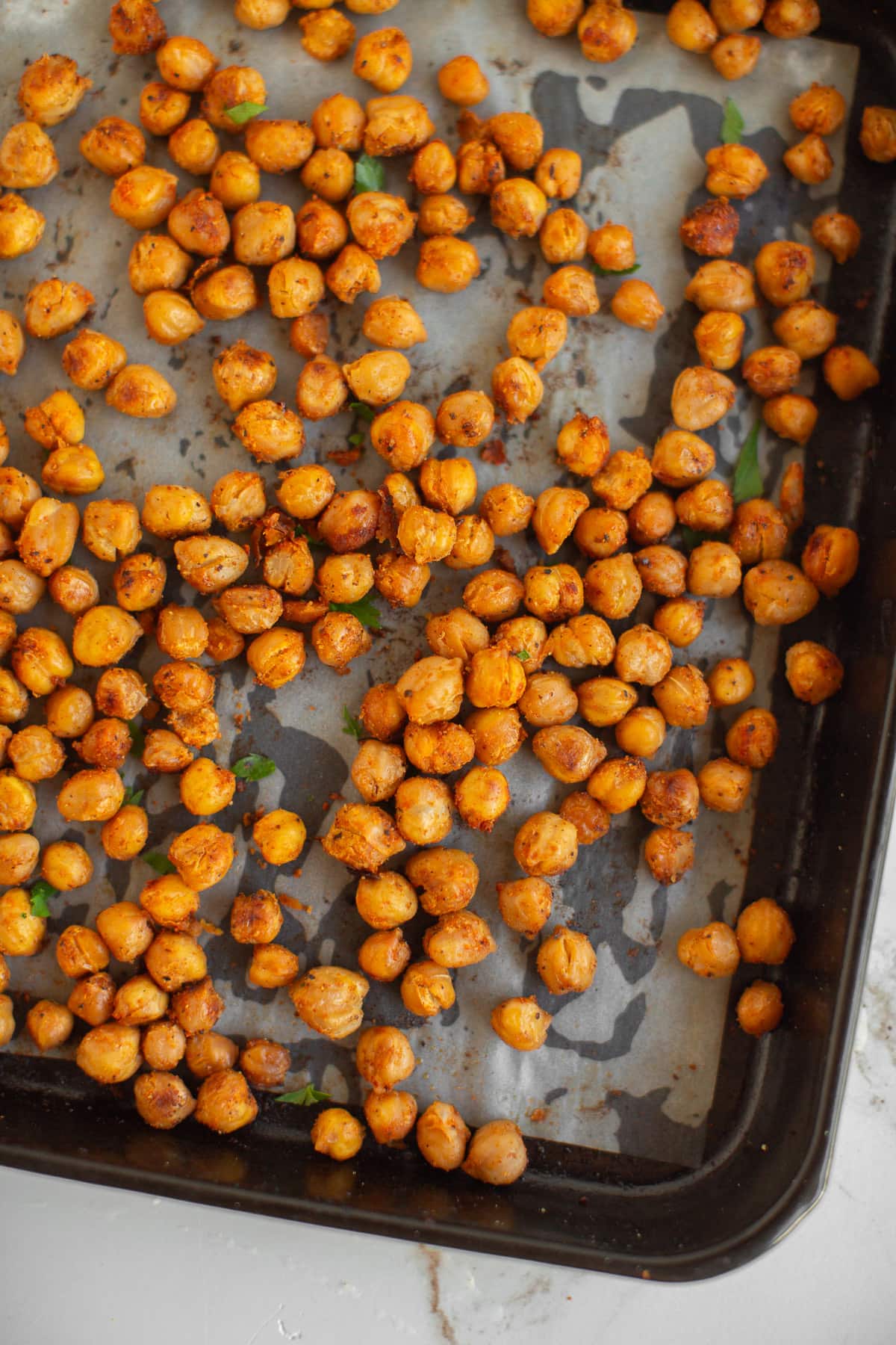 Roasted chickpeas on a baking sheet.