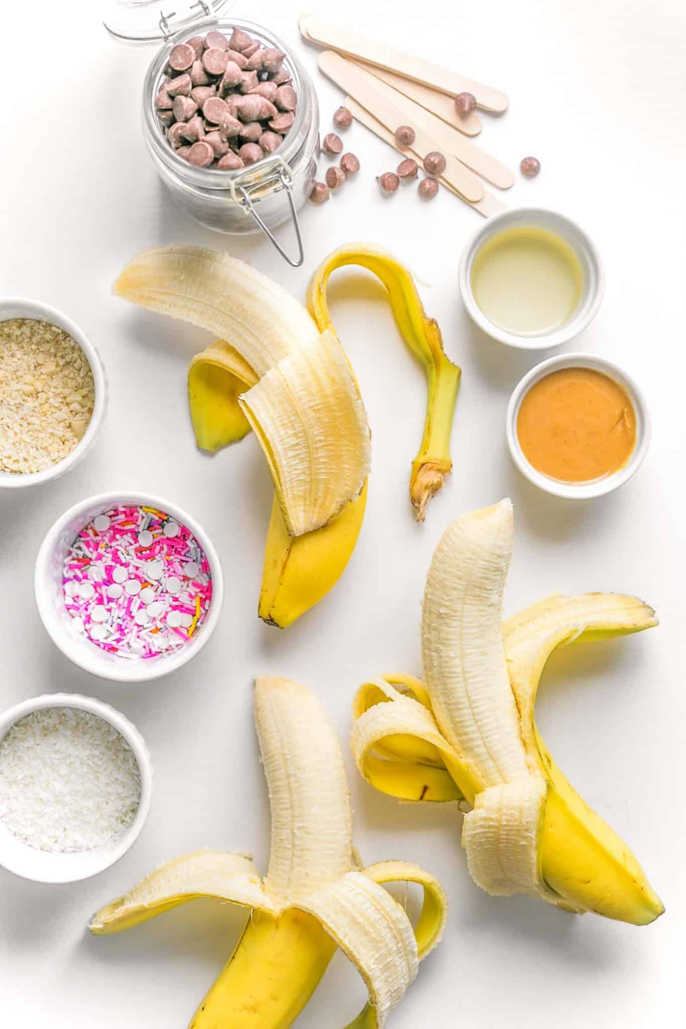 Peeled bananas on a counter with sprinkles.