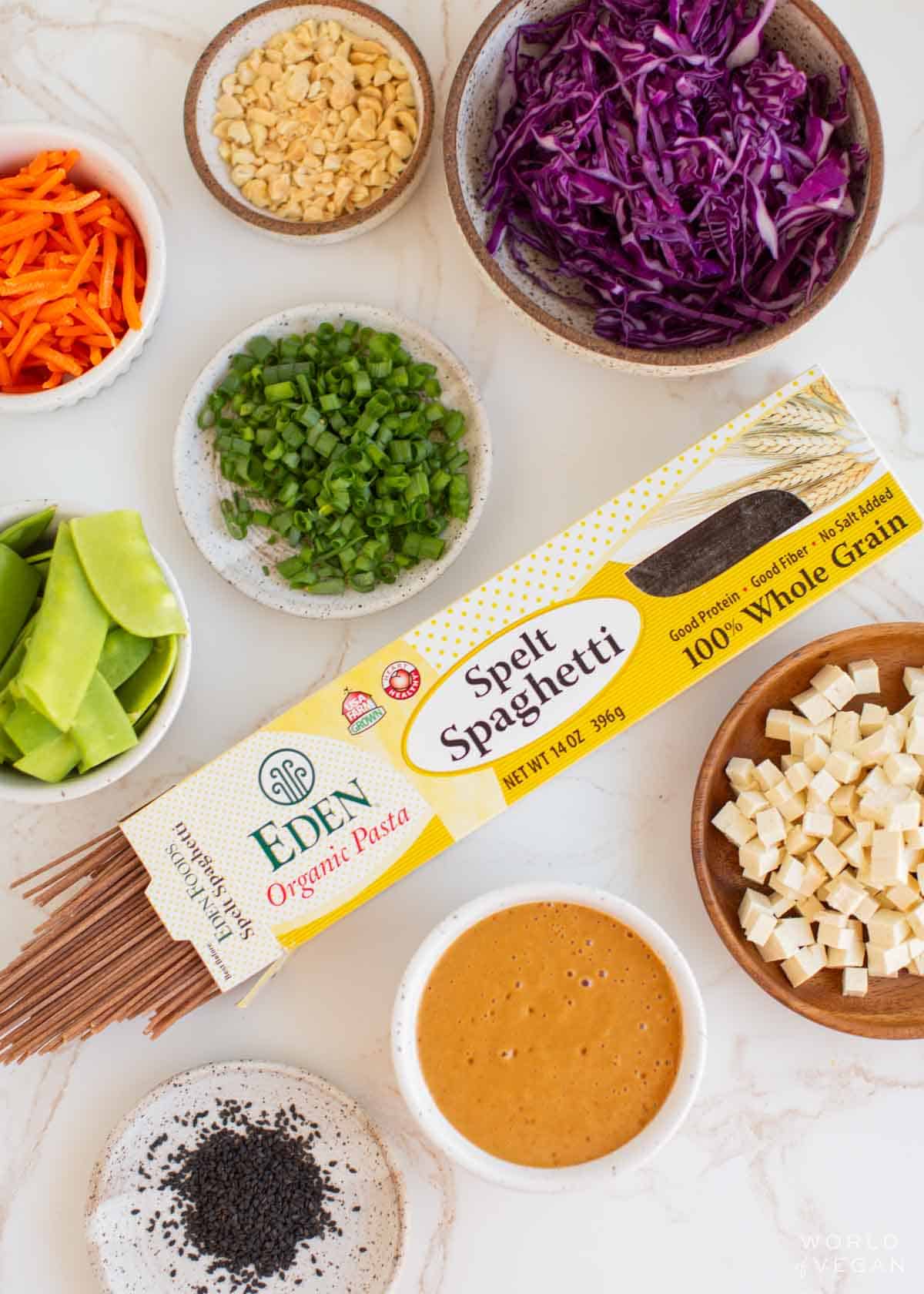 Ingredients for the cold noodle salad placed into various bowls.