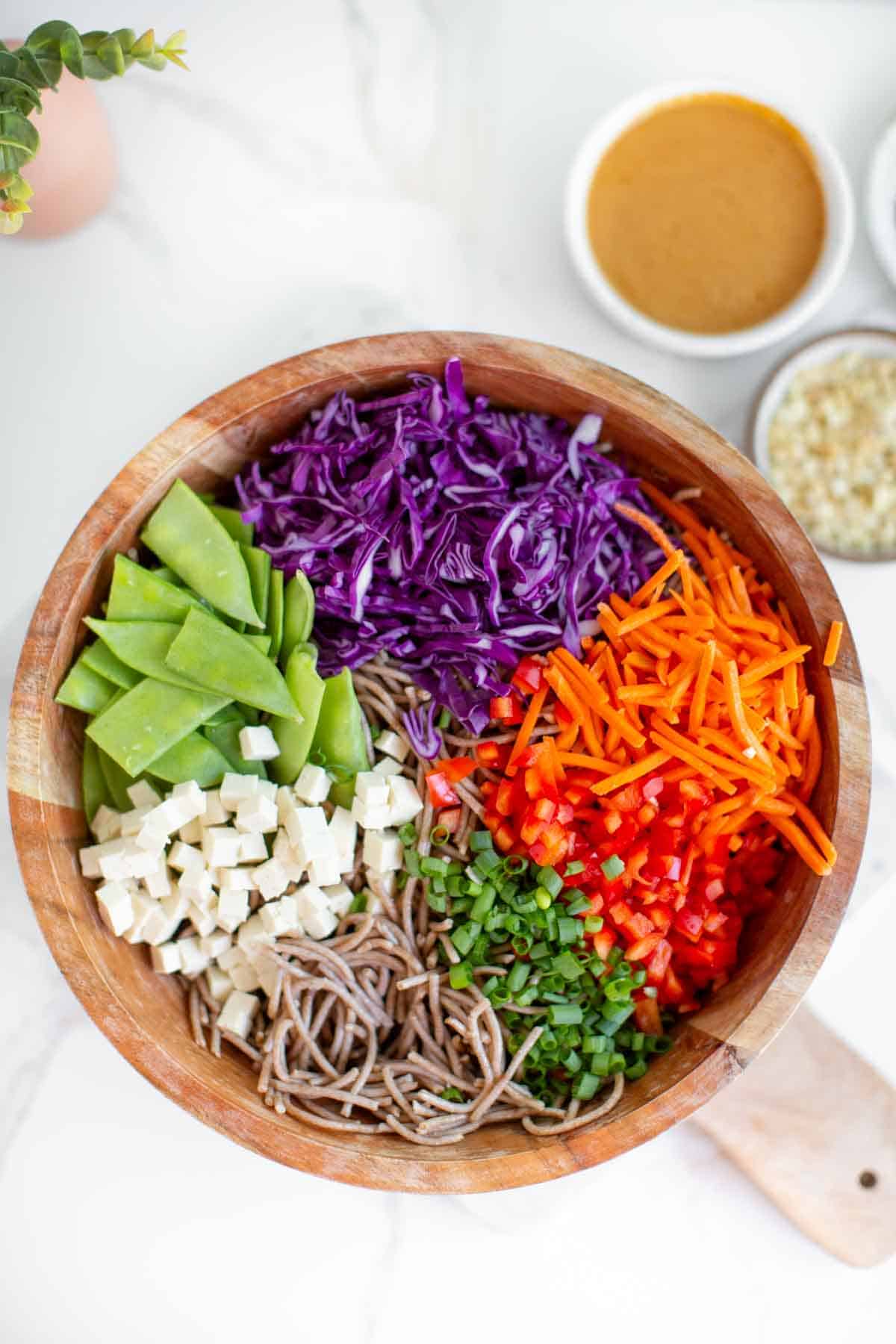 Ingredients for the cold noodle salad added to a large mixing bowl.