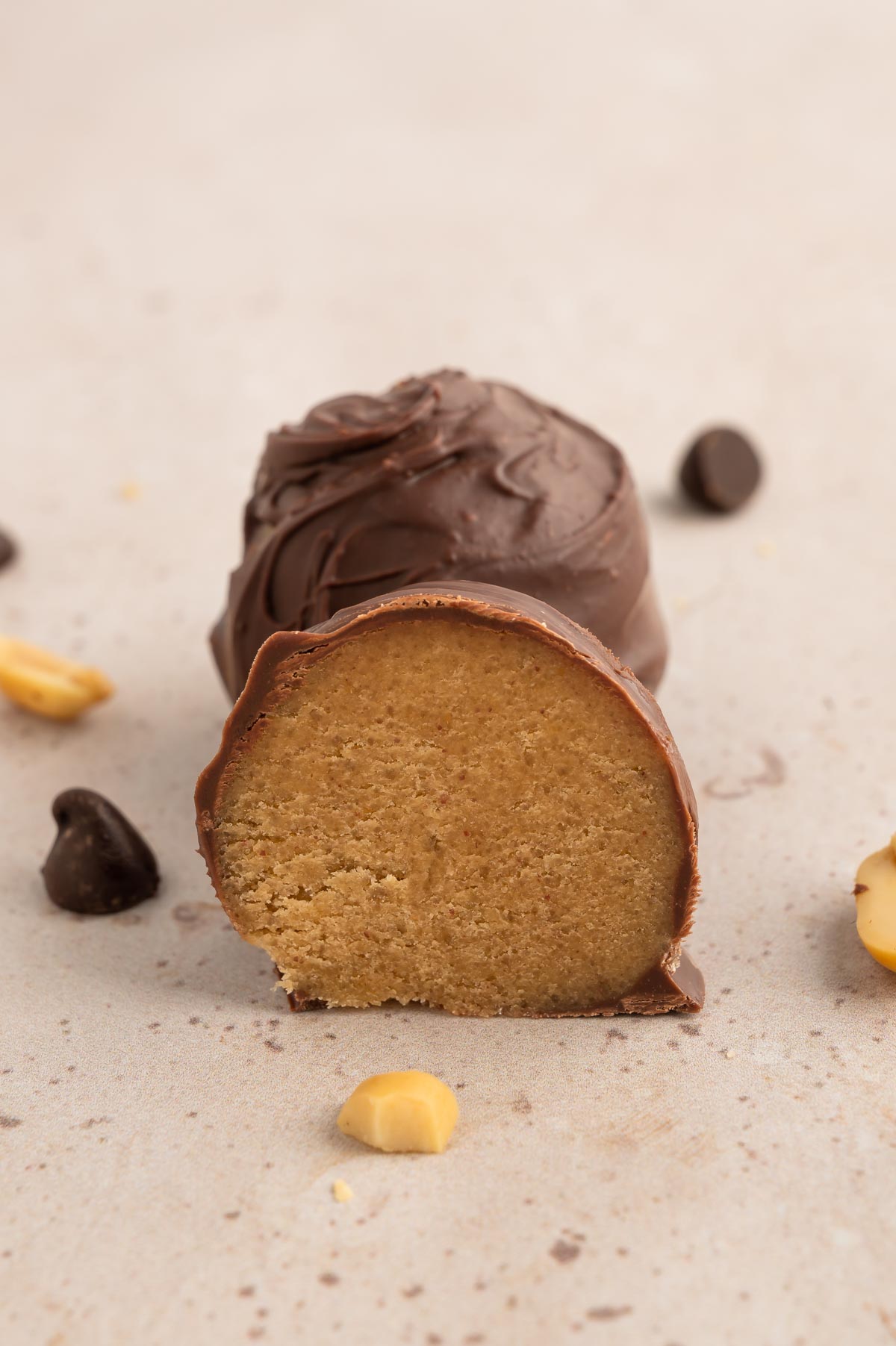 A chocolate-covered cookie dough ball, cut in half.