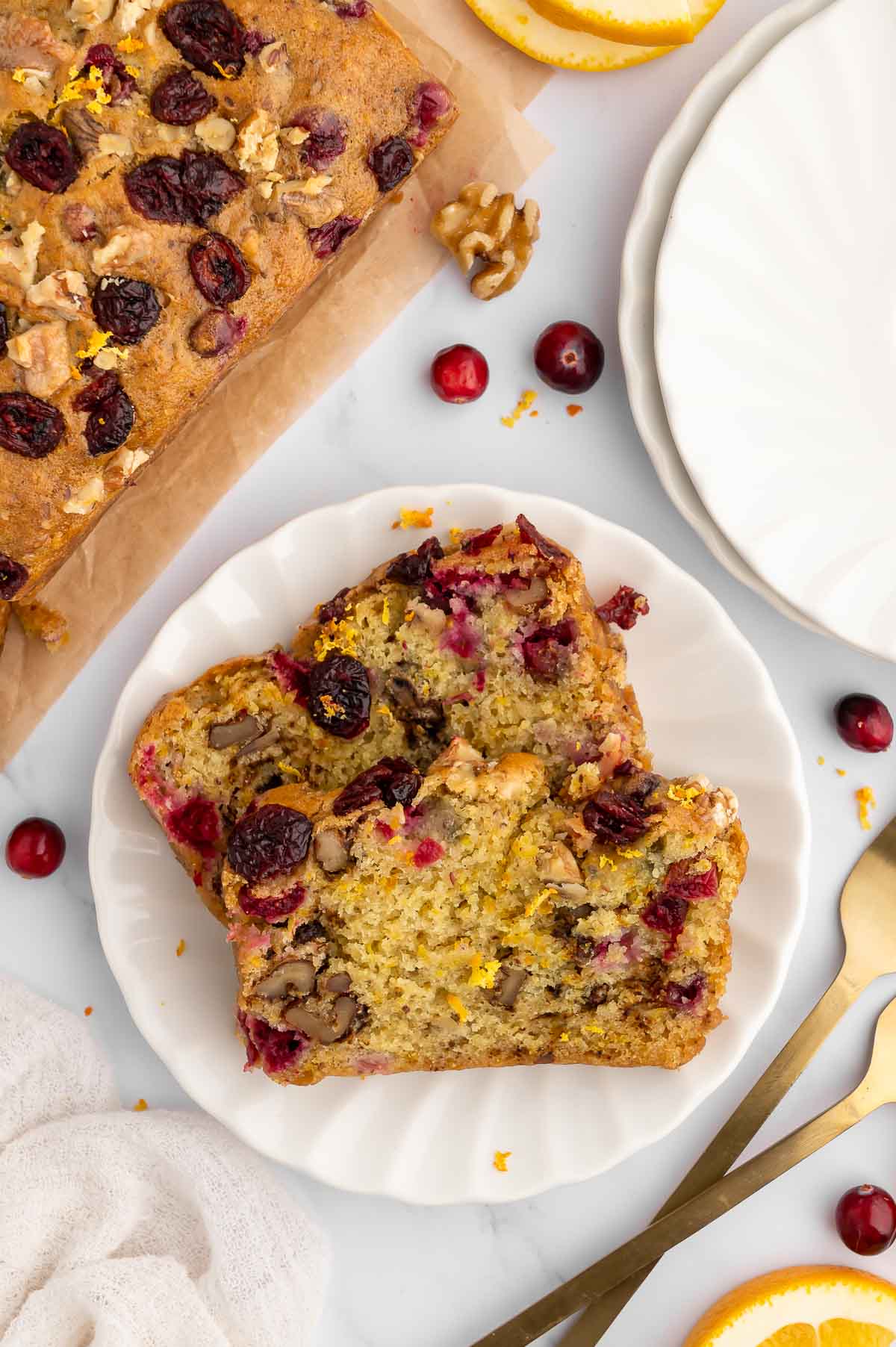 Walnut cranberry bread sliced on a plate.