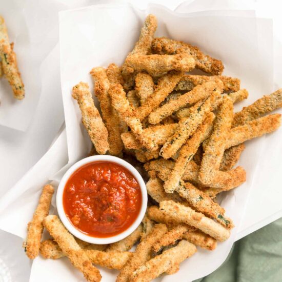 Basket of air fryer zucchini fries With Marinara Sauce Dip