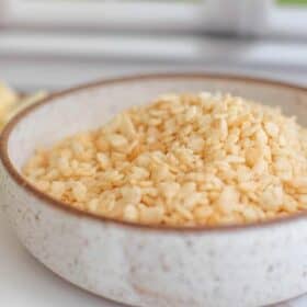 Bowl of vegan rice krispies puffed rice cereal.