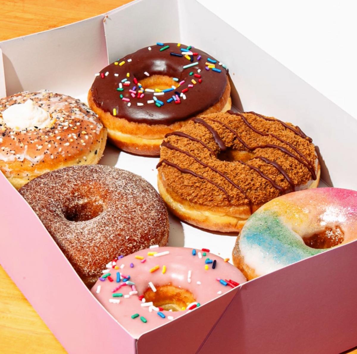 An assortment of vegan donuts in a box from Dough Joy.