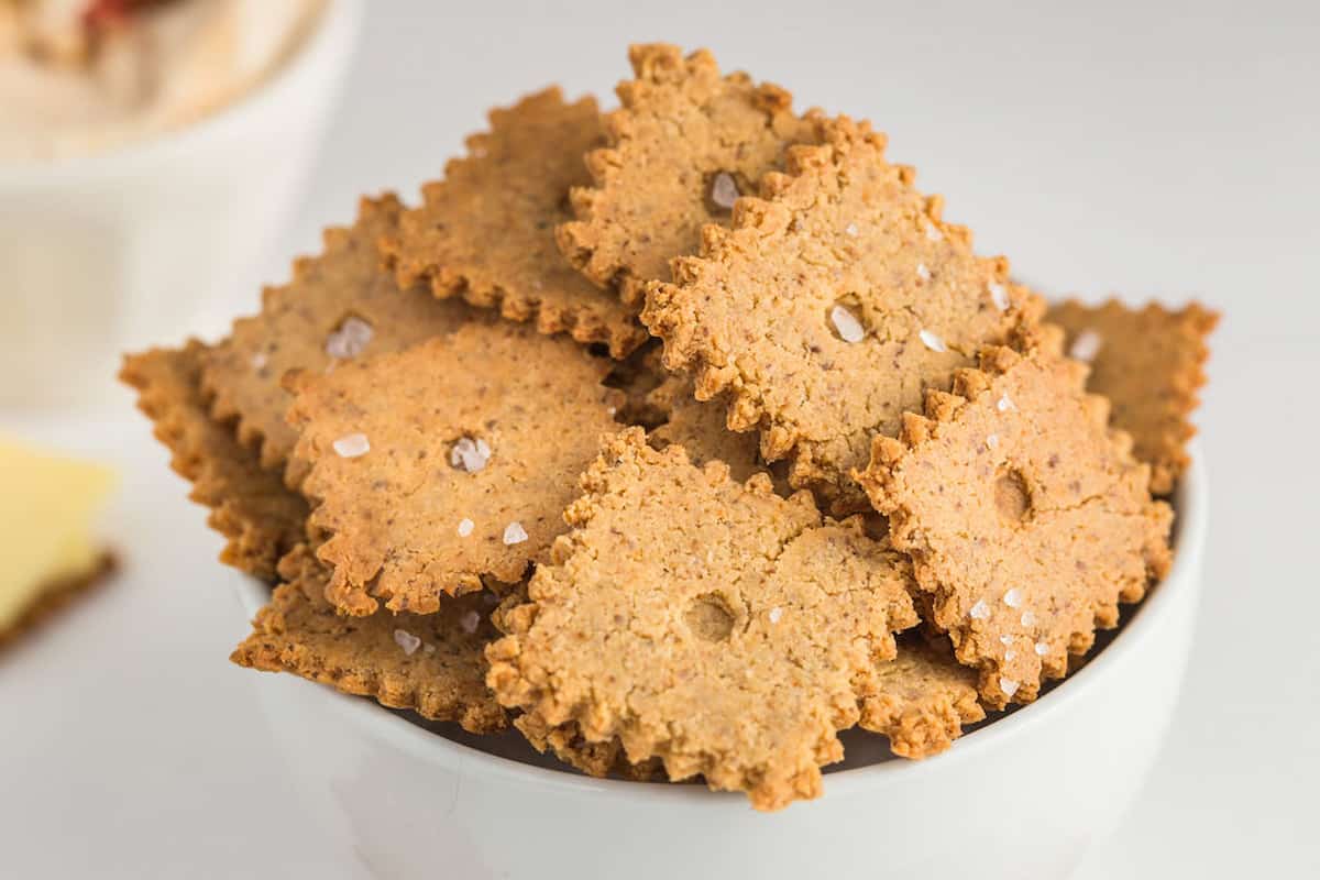 A white bowl with almond flour crackers.