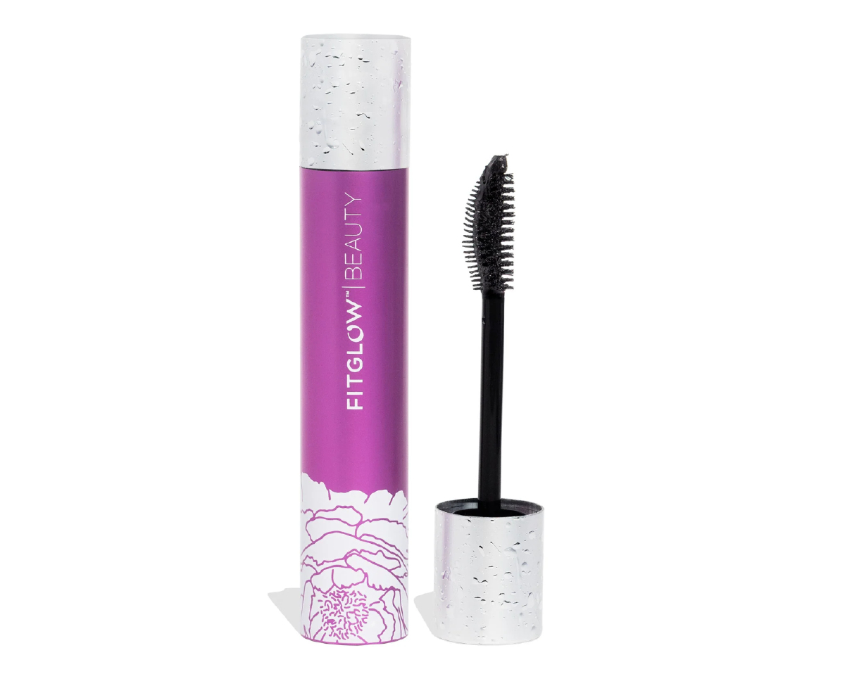 A purple and silver Fit Glow Beauty mascara tube next to the silver and black mascara wand on a white background. 