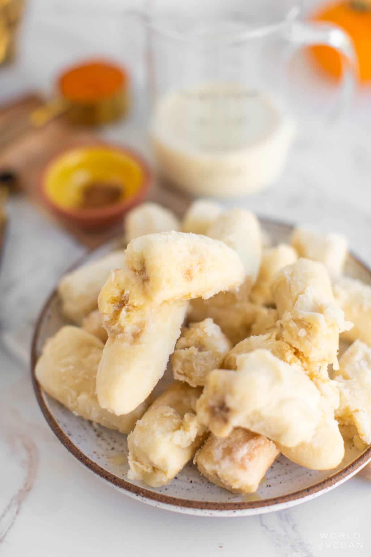 Chopped frozen bananas on a plate.