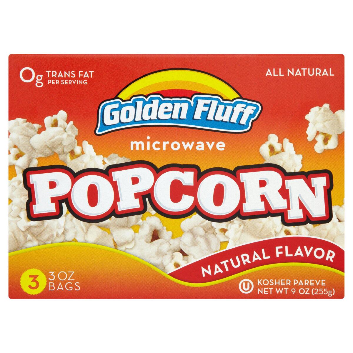 A red and orange box of Golden Fluff microwave, vegan-friendly popcorn against a white background. 