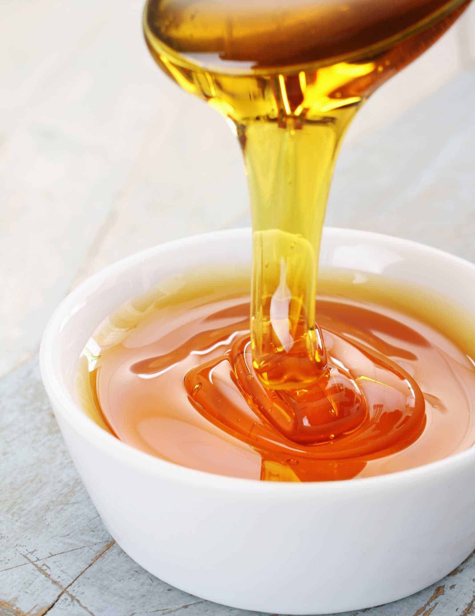 golden syrup thick viscous in a white ramekin