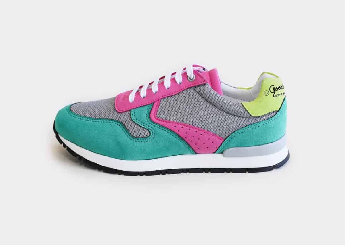 A single vegan running shoe from Good Guys Don't Wear Leather in colors of bright pink, lime, turquoise and gray on a white background.