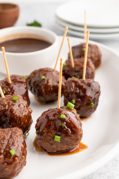 Vegan bbq sauce meatballs served on a platter with toothpicks.