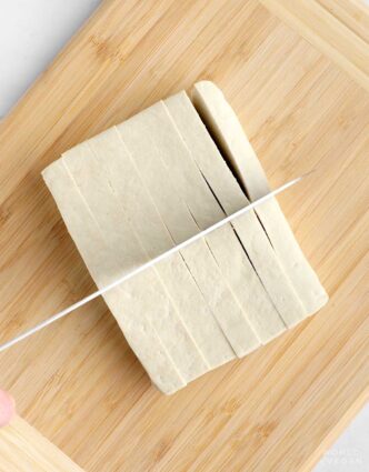 Cutting tofu into french fry shape.