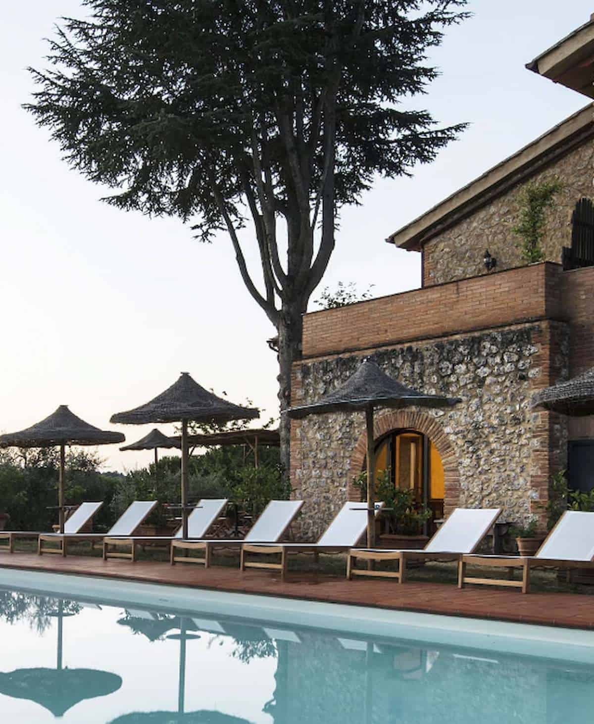 Pool and lounge chairs at I Pini Agrivilla in Tuscany.