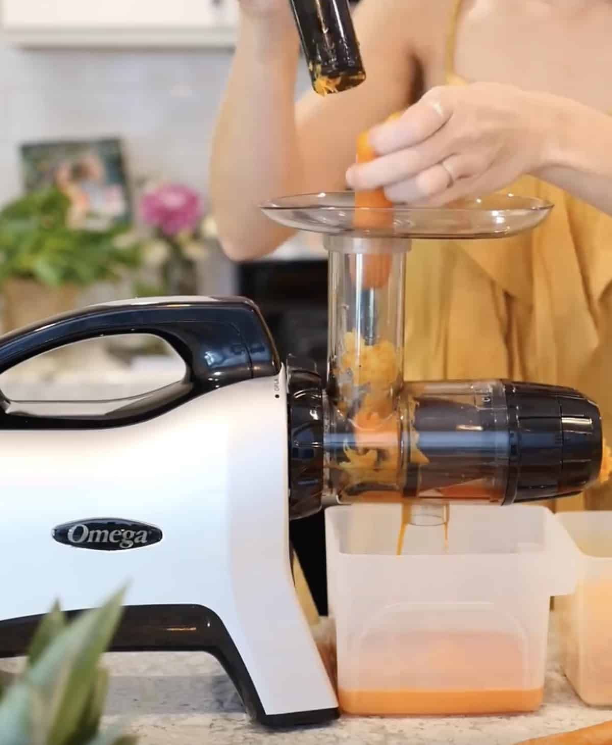 Michelle Cehn juicing raw carrots in the omega masticating juicer