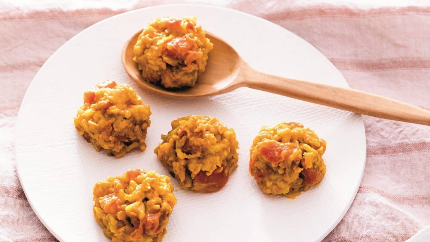 Rice and lentil khichdi on a wooden spoon.