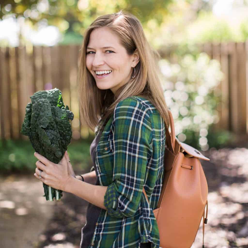 Michelle Cehn holding bunch of fresh lacinato dino kale