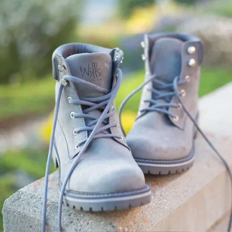 Pair of grey high top women's vegan microsuede boots with vegan label.