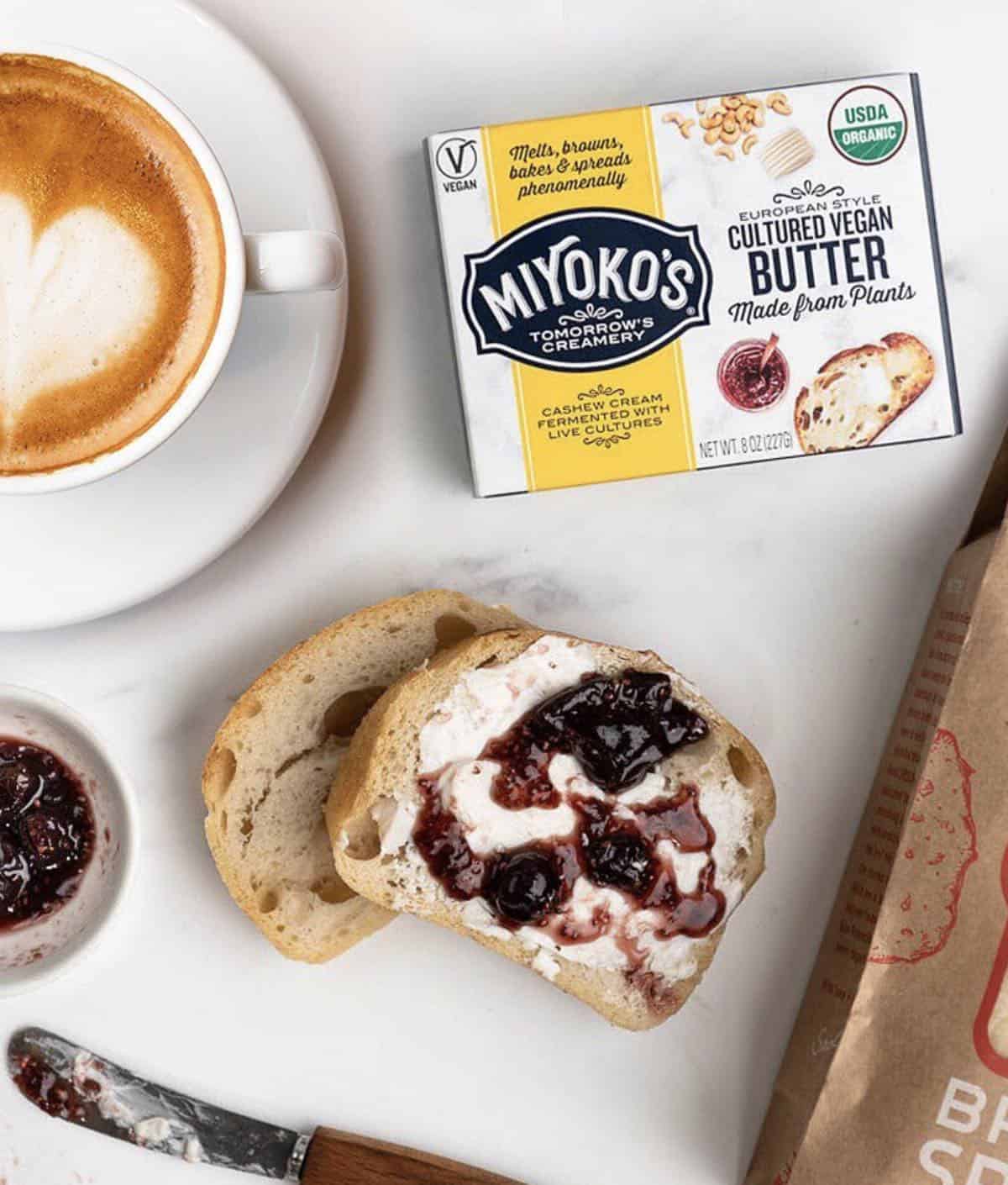 package of miyokos vegan butter with toast and frothy cup of coffee