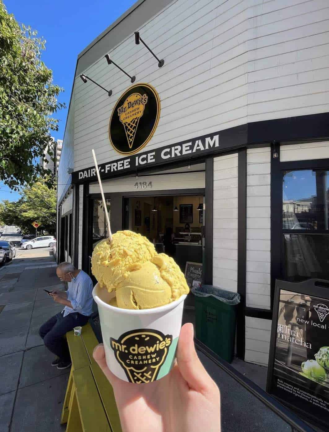 holding up Mr Dewies cashew vegan ice cream shop in oakland