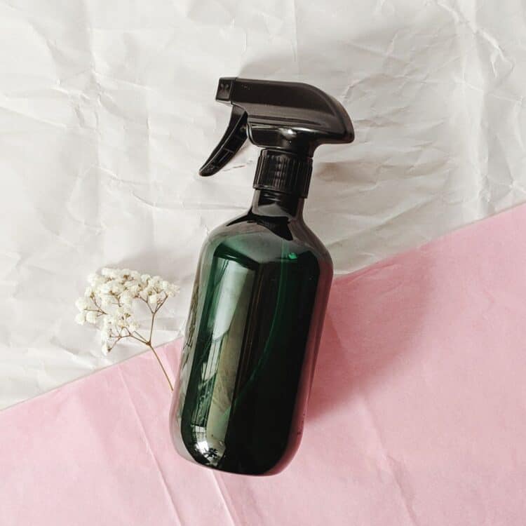 Glass bottle filled with natural disinfectant spray.