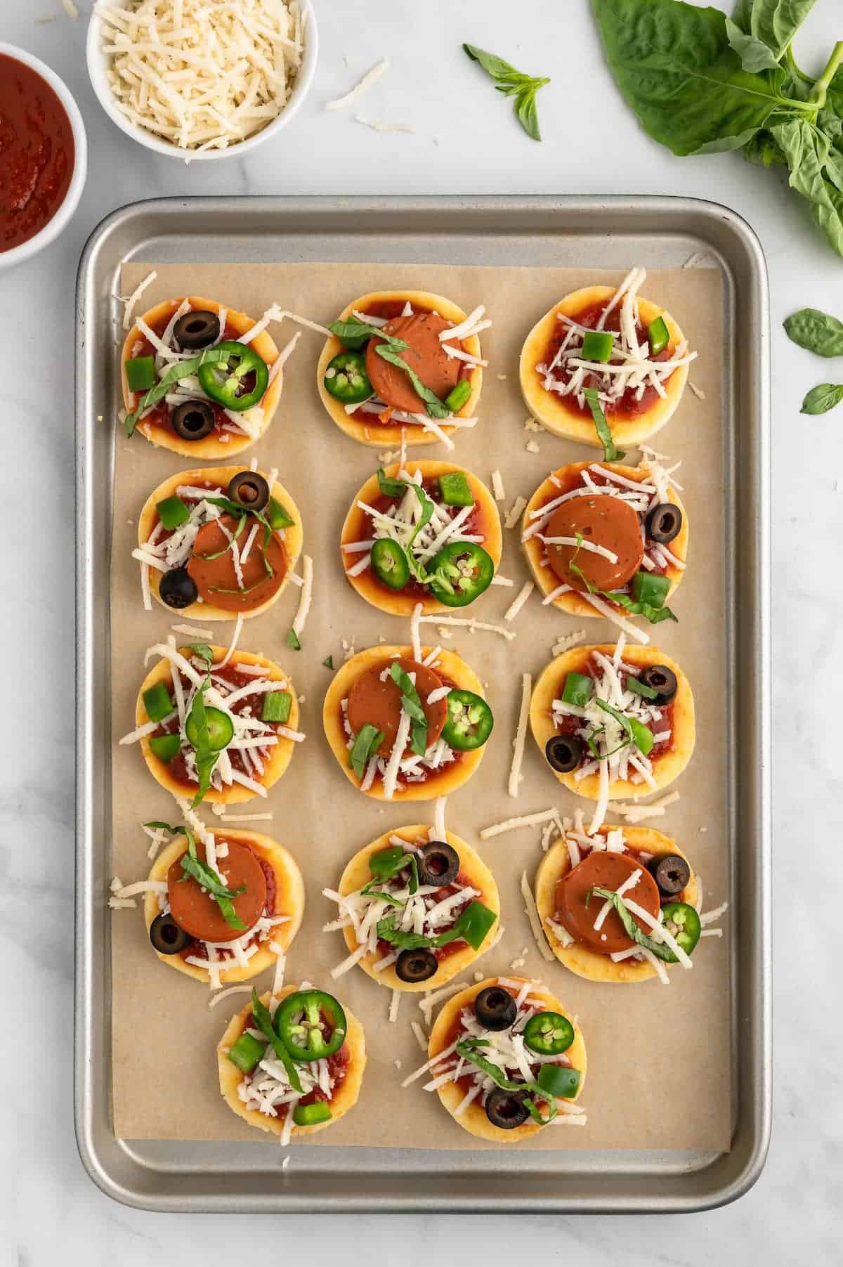 Polenta pizza bites on a baking tray.