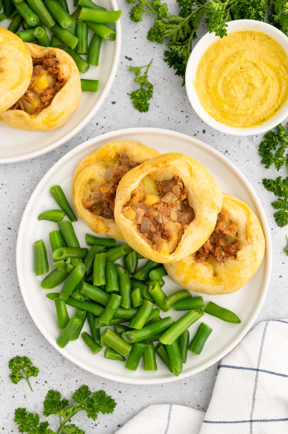 The best homemade potato knish pastries served with green beans and parsley.
