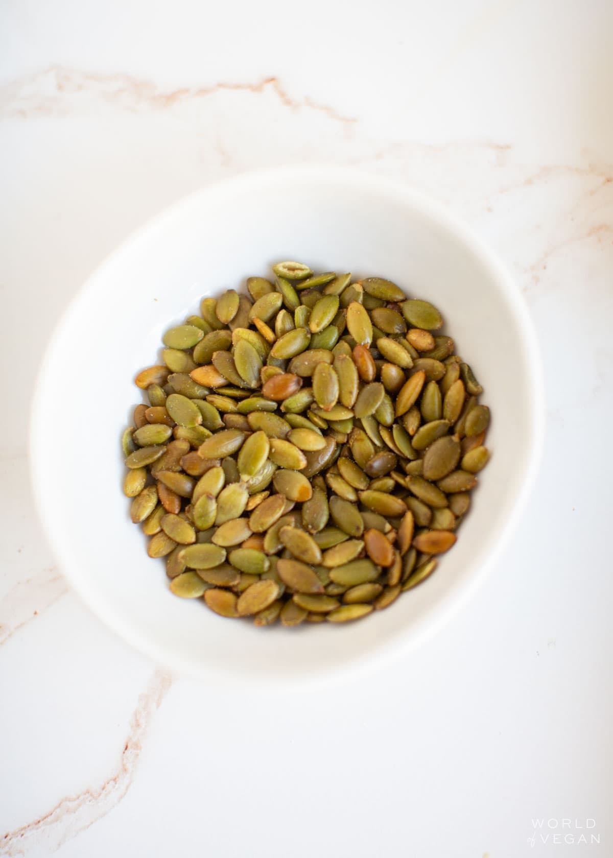 A small bowl of pepita pumpkin seeds.