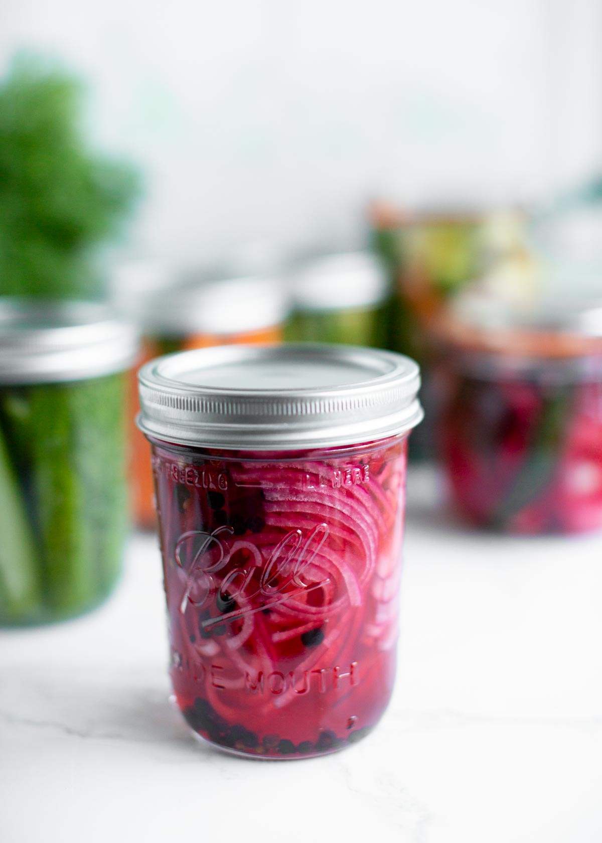 Quick pickled red onion in a glass jar.