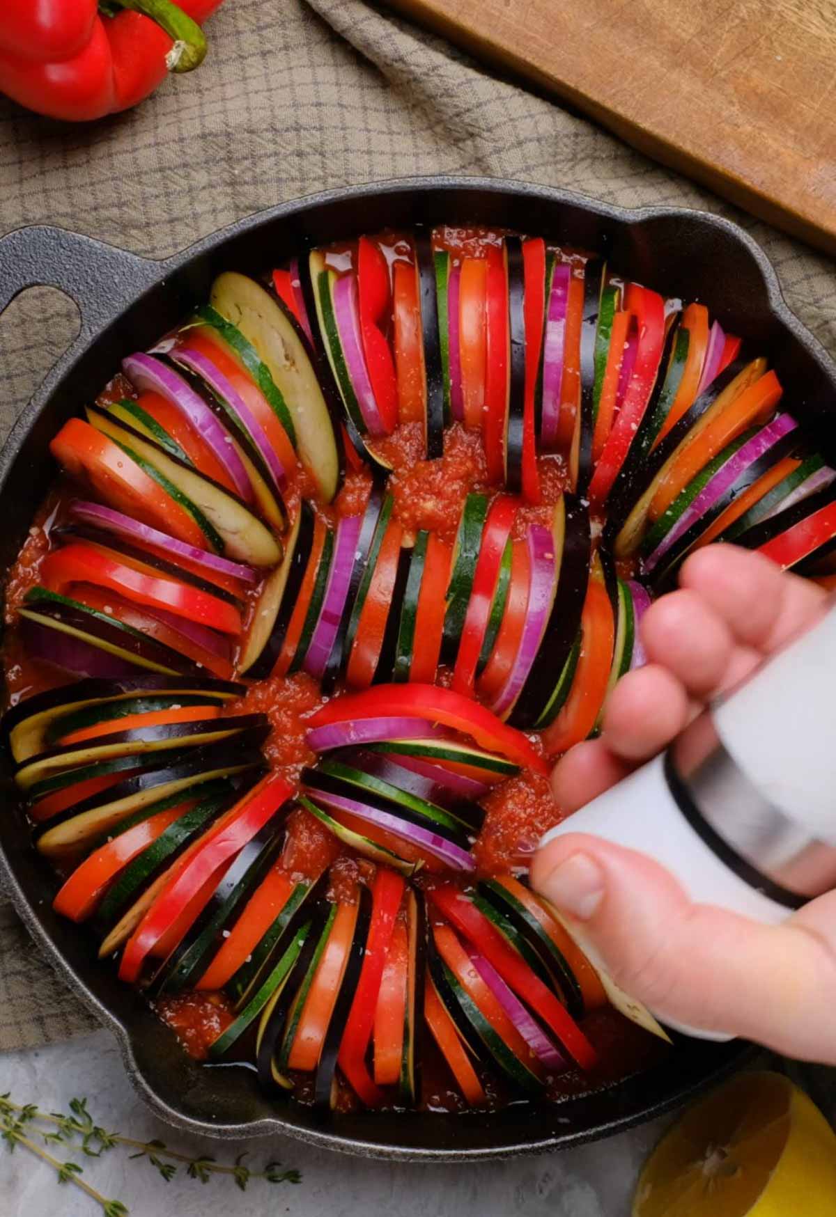 Seasoning ratatouille in a pan.
