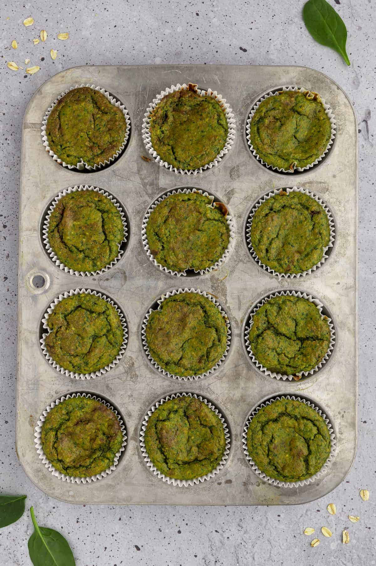 Spinach banana muffins in a muffin tin.