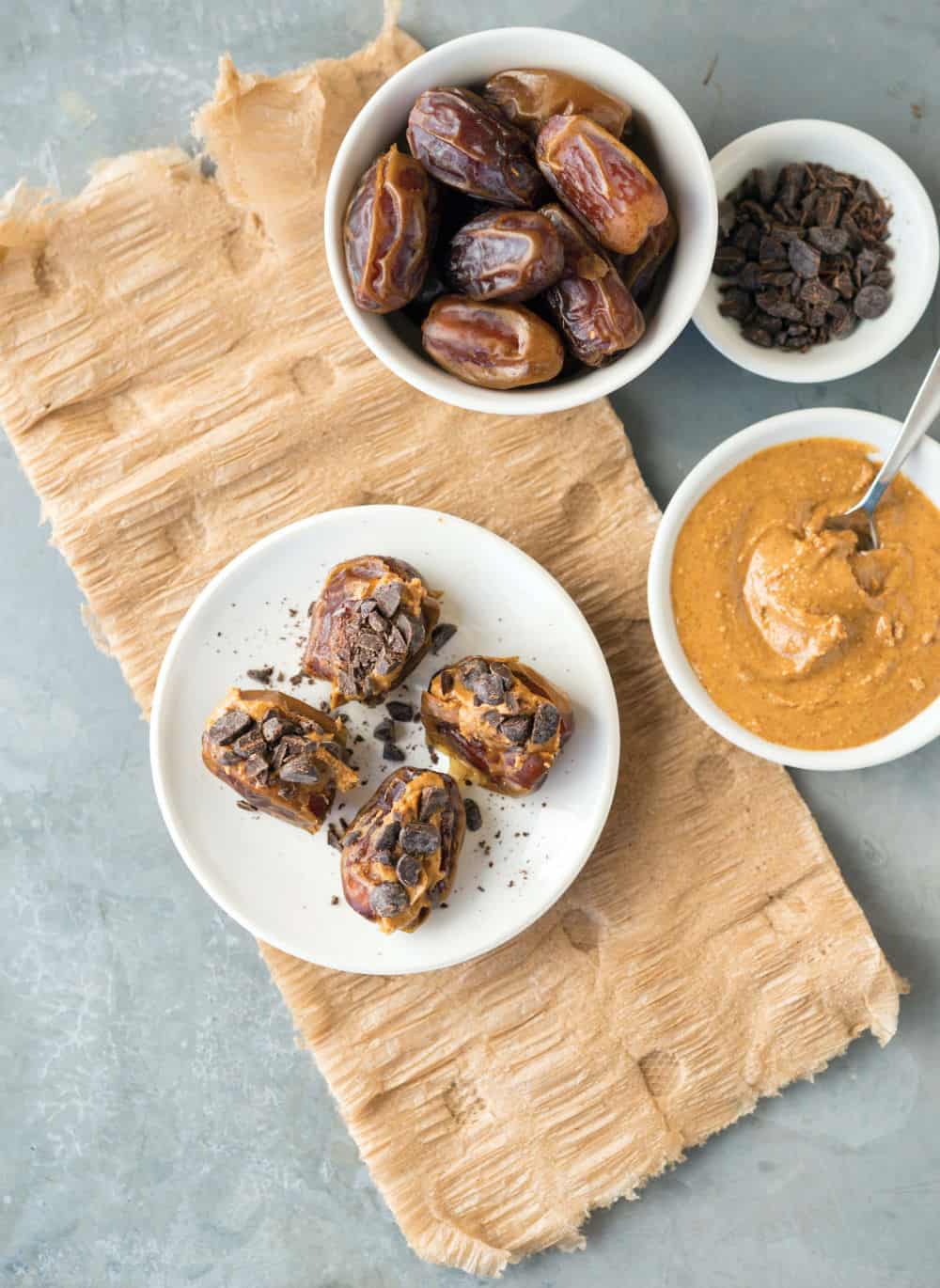 Dates stuffed with peanut butter and chocolate chunks on a plate. 