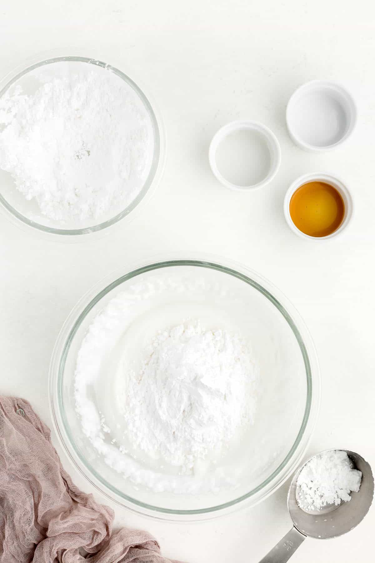 More powdered sugar added to the royal icing bowl.