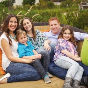 Vegan family sitting on a couch together.