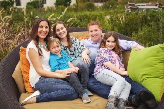 Vegan family sitting on a couch together.