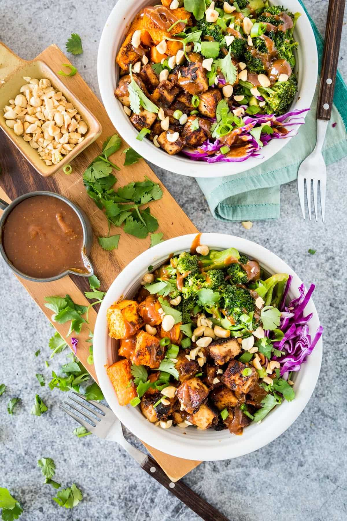 Two bowls of Thai peanut tofu and sweet potato bowls.